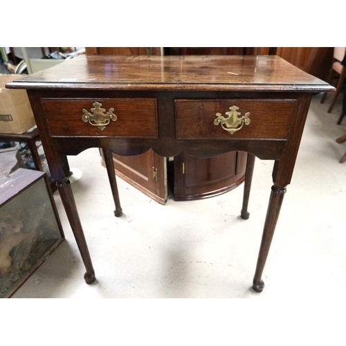 850 - A 19th Century oak low boy with two drawers, brass handles, turned legs on pad feet.