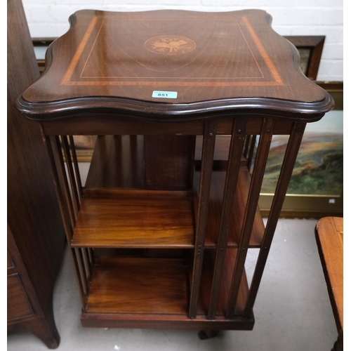 851 - An inlaid mahogany rotating book case in the Sheraton manor, inlaid instrument to top.