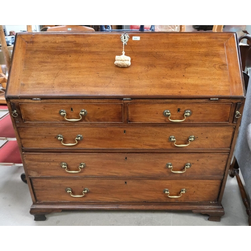 855 - A large Georgian mahogany bureau with decorative interior with secret compartments, three long and t... 