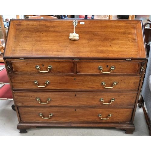 855 - A large Georgian mahogany bureau with decorative interior with secret compartments, three long and t... 