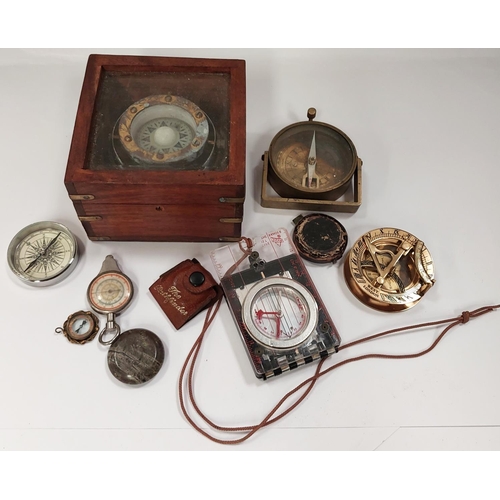 205 - A early 20th century compass pendant in gilt and a selection of other compasses