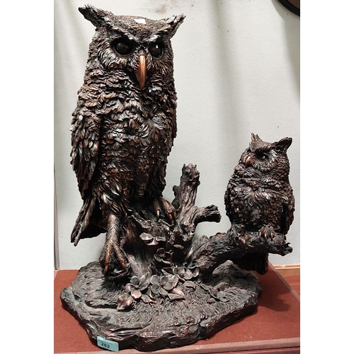 282 - A large resin group of an owl with young on tree branch, bronzed finish, height 58cm.