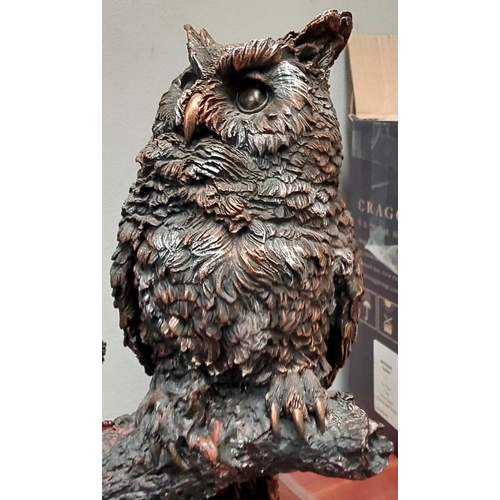 282 - A large resin group of an owl with young on tree branch, bronzed finish, height 58cm.