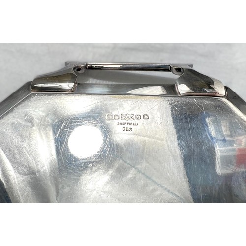 627 - An Art Deco style stretched octagonal two handled silver plated tray with Celtic design border