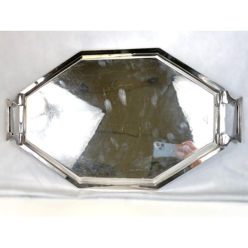 627 - An Art Deco style stretched octagonal two handled silver plated tray with Celtic design border