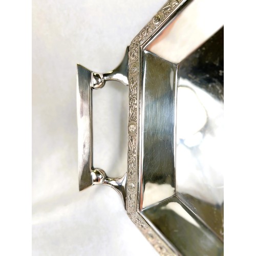 627 - An Art Deco style stretched octagonal two handled silver plated tray with Celtic design border