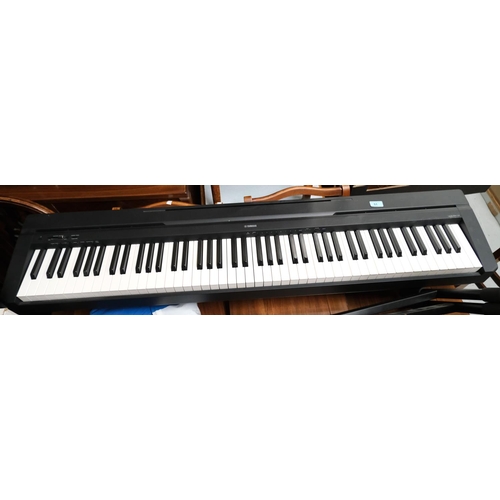 51 - A Yamaha digital piano R35 on stand.