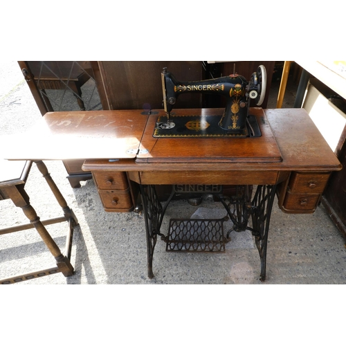 936 - A Singer oak cased treadle sewing machine.