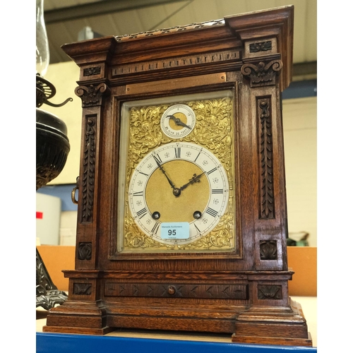 95 - A Victorian carved oak bracket clock with brass dial and ting tang movement.