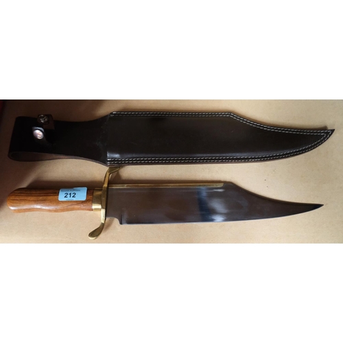 212 - A large Bowie knife with polished wooden handle, brass fittings, polished blade, length 32cm with sh... 