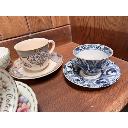 425A - A selection of Royal Albert teaware, Japanese and other cups and saucers.