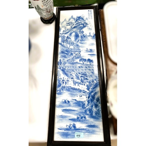 410 - A Chinese framed ceramic blue and white rectangular panel with traditional decoration (crack) and a ... 