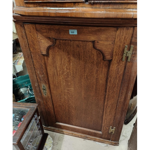 849 - An 18th Century oak corner cupboard with raised arch panel doors.