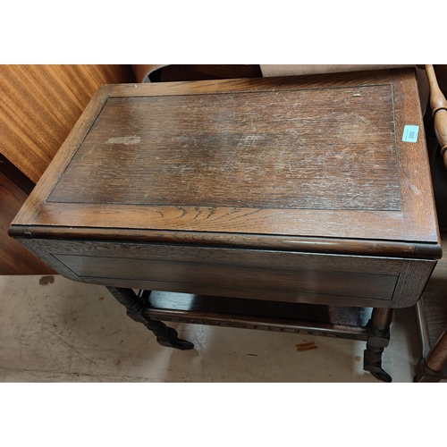 860 - An oak Jacobean style drop leaf tea trolley and two folding bridge/card tables.