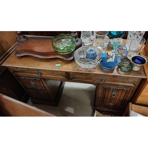 868 - An oak carved desk with two top drawers and four pedestal drawers; a mid 20th Century teak and leath... 