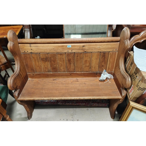 887 - A pitch pine two seater panelled bench, 109cm