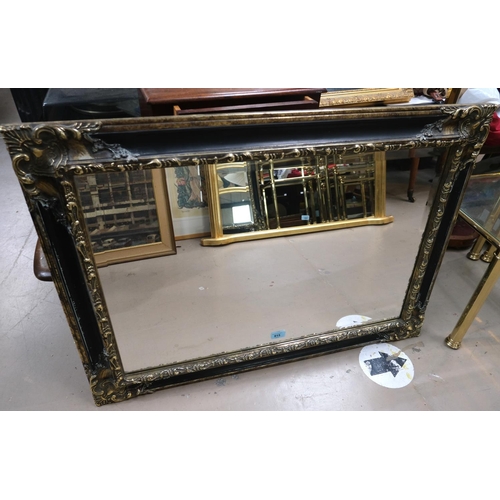 915 - A classical style black and gilt mirror with shell decoration, 65x90cm and a gilt frame mirror, 73x1... 