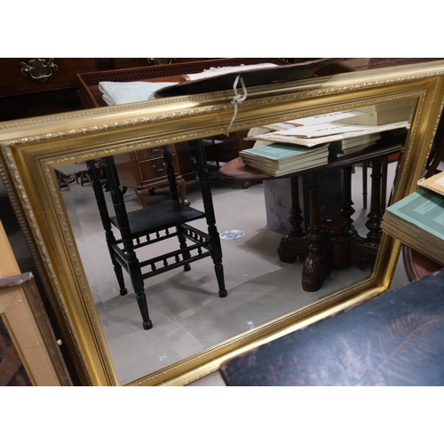 915 - A classical style black and gilt mirror with shell decoration, 65x90cm and a gilt frame mirror, 73x1... 