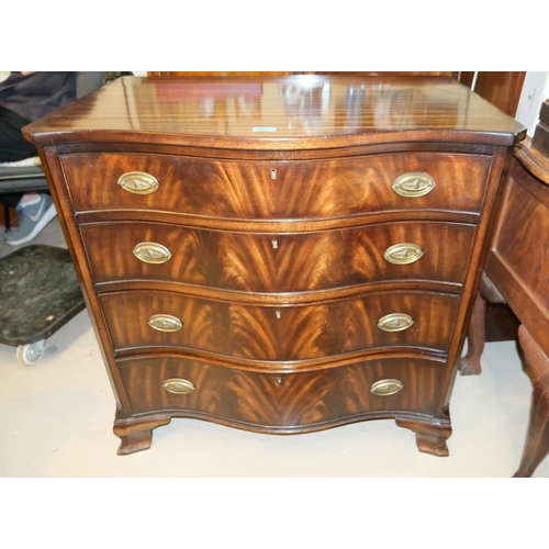 916 - A mahogany serpentine fronted bachelors desk with four long drawers 80x84x52cm.