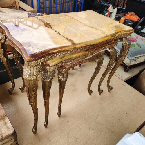 975B - A nest of 3 onyx and gilt occasional tables