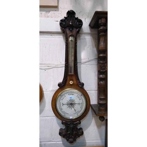 982 - A large 19th Century carved walnut mercury column barometer with thermometer and white scale.