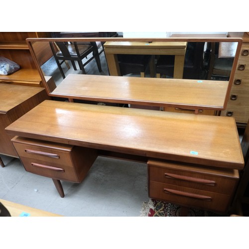 960B - A G-Plan 1970's teak kneehole dressing table with 4 drawers and central slide and stool