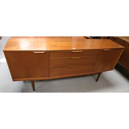 897 - A mid 20th Century teak long low sideboard with three central drawers and cupboard to each end.184 x... 