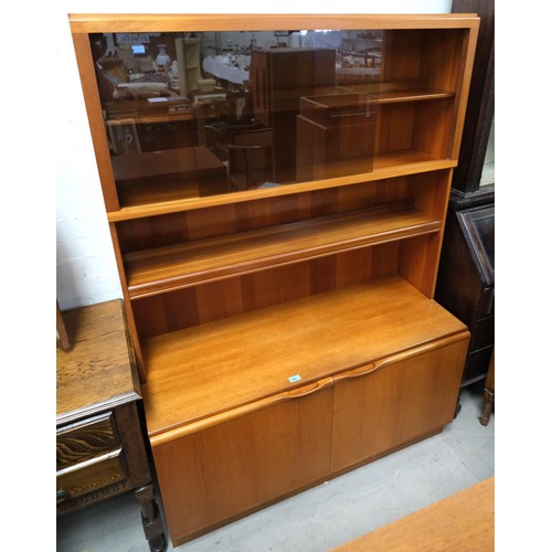 960 - A Mackintosh teak wall unit wit shelves enclosed by smoky glass doors over double door cupboard.