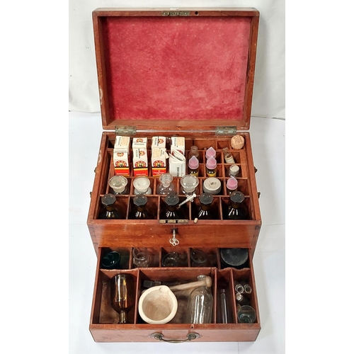 187A - A 19th century wooden apothecaries chest with later vintage glass medical bottles bottles, pestle an... 