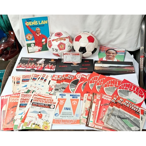 202 - A box of sporting memorabilia including 2 footballs, Manchester United members packs etc.