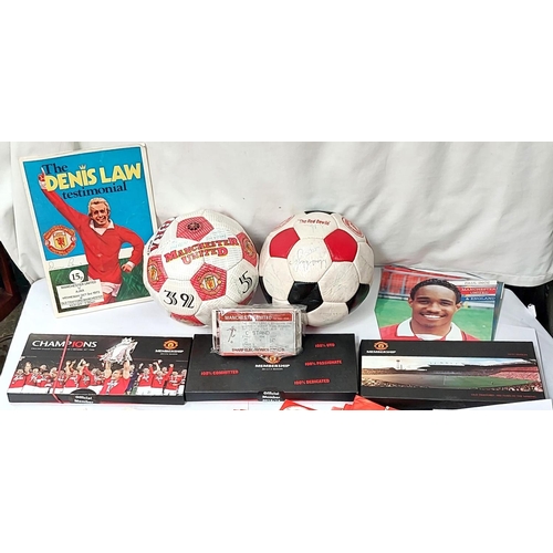 202 - A box of sporting memorabilia including 2 footballs, Manchester United members packs etc.