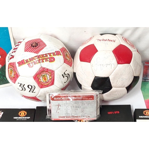 202 - A box of sporting memorabilia including 2 footballs, Manchester United members packs etc.