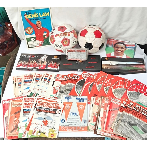 202 - A box of sporting memorabilia including 2 footballs, Manchester United members packs etc.