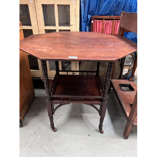 939 - An Edwardian octagonal mahogany occasional table with galleried under tier and turned legs