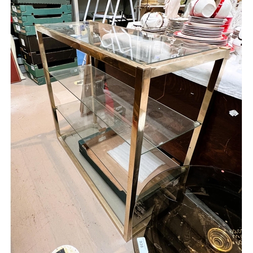 969A - A gilt metal and glass 4 height wall unit.