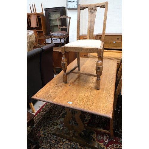 966 - An oak dining table with four matching chairs