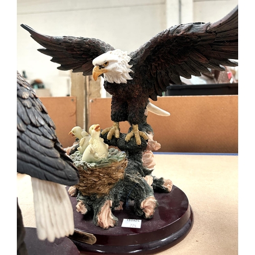 98 - Three resin figures of eagles including one with eaglets; four modern resin owl figures.