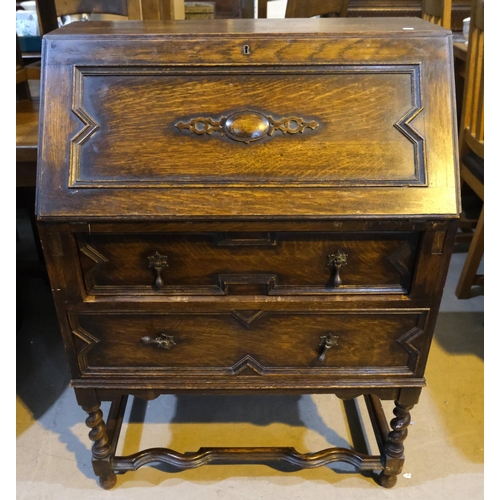 1031 - A 1930's oak bureau with barley twist support and fall front.