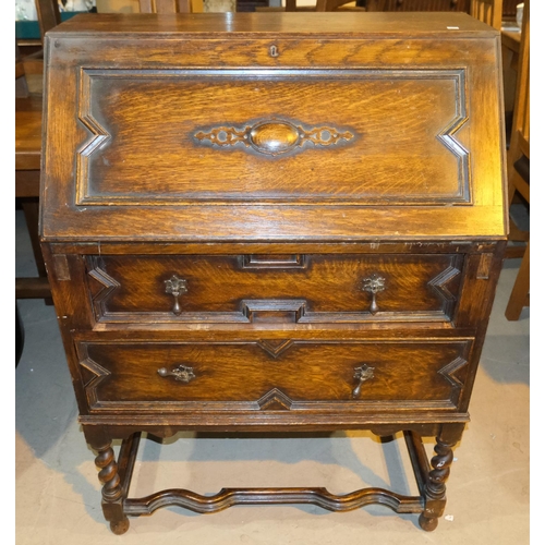 1031 - A 1930's oak bureau with barley twist support and fall front.