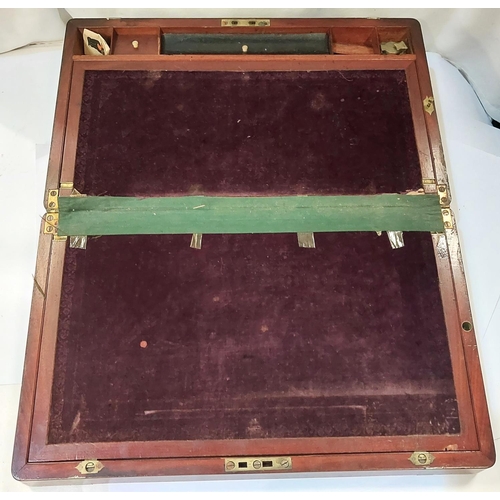 4 - A 19th century mahogany campaign writing desk with brass bindings, an ink well, fitted handles etc