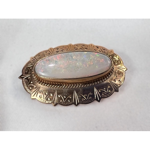 764 - A 9 carat gold brooch set with large oval opal, 3cm, a 9 carat gold horse shoe brooch and a yellow m... 