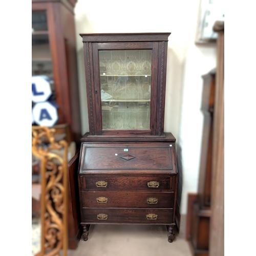 1009 - A matched full height oak bureau bookcase with glazed door above fall front and drawers below.