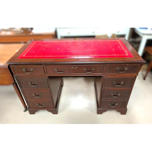 1023A - A reproduction desk with drawers to each pillar, red writing surface