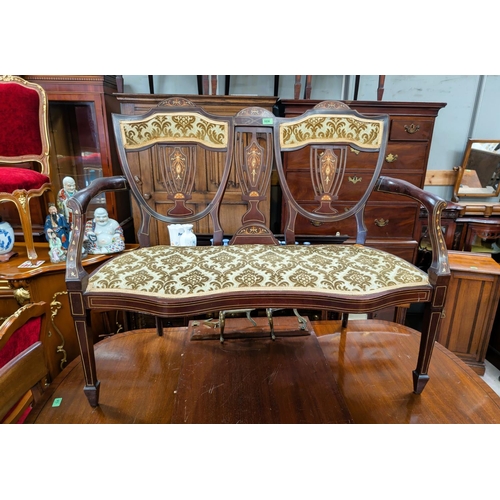 1038 - An Edwardian mahogany inlaid two-seater settee with extensive inlay, shield backs.