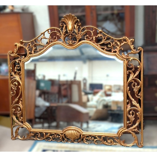 1055 - A large and impressive Rococo style mirror with gilt pierced border with shell decoration and scroll... 