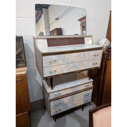 1062 - Two piece 1950's bedroom suite in white, comprising dressing chest with mirror and chest of drawers.