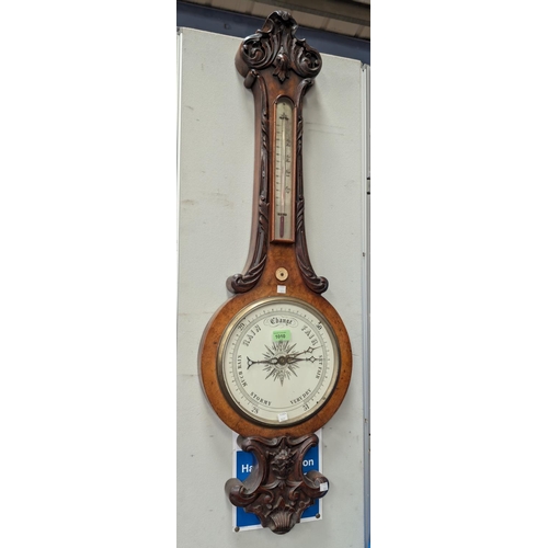 1010 - A large 19th Century carved walnut mercury column barometer with thermometer and white scale.