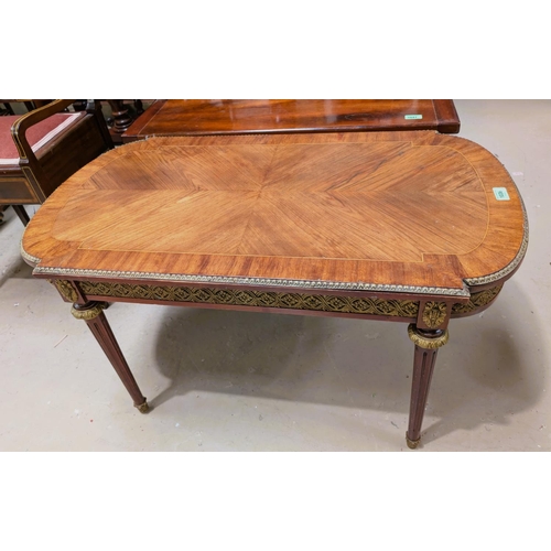 1036 - A French Empire style oval coffee table with brass mounts.