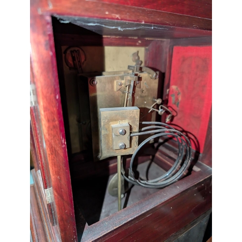 13 - An early 20th century mahogany cased mantel clock and pedestal stand with opening door.