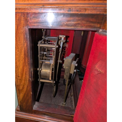 13 - An early 20th century mahogany cased mantel clock and pedestal stand with opening door.